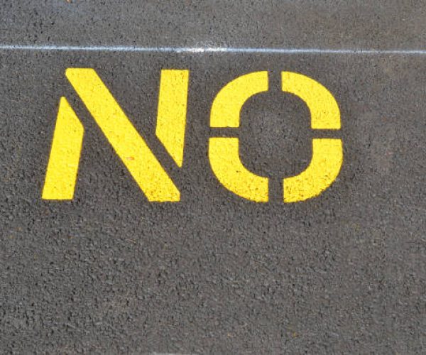 No Parking sign on asphalt lot